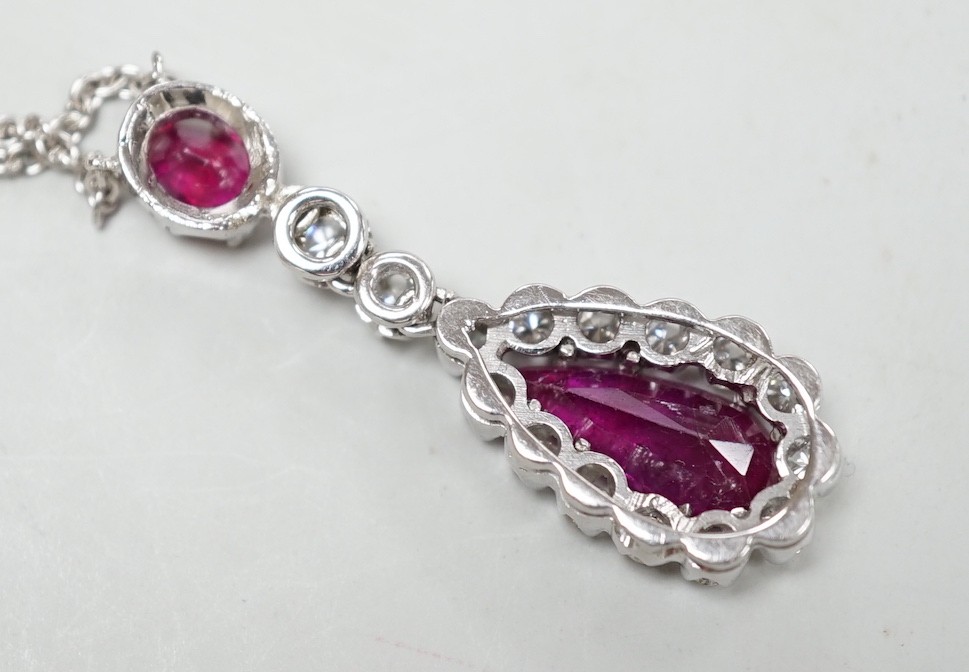 A modern 750 white metal, two stone ruby and fifteen stone diamond set pear shaped drop pendant necklace, pendant, 34mm, chain, 40cm, gross weight, 7.1 grams.
